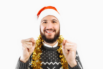 A man with a beard in a Santa Claus hat holding Christmas balls, Christmas-tree decorations