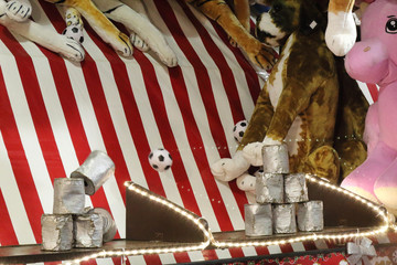 Stacked jars being hit by a ball, among stuffed animals, in an attraction in the Gorsedd Gardens amusement park in Bristol, United Kingdom