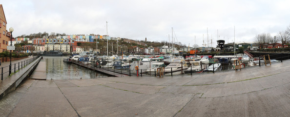 Bristol Marina and Rowing Club, with many docked boats and a paved concrete descent to move boats in and out the water, in a cloudy winter day, in UK