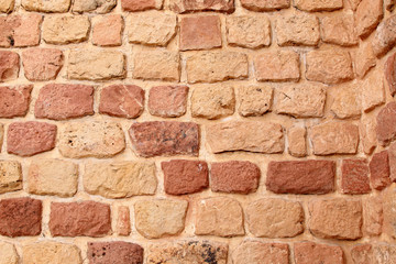 Red vintage brick wall background. Uneven vintage bricks.