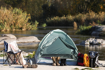 Set of equipment near camping tent outdoors