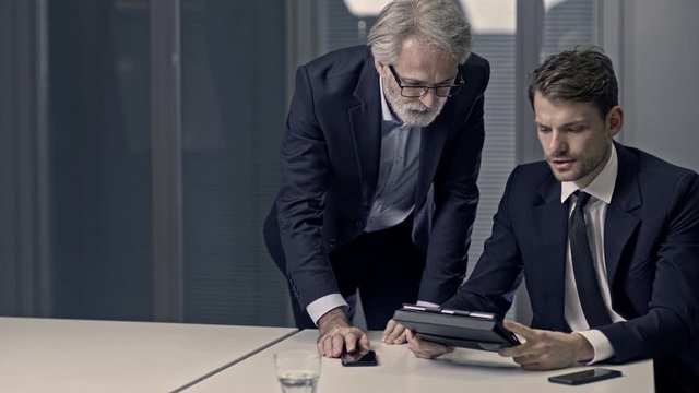 A couple of bussinessmen and bussines woman discussing an important topic