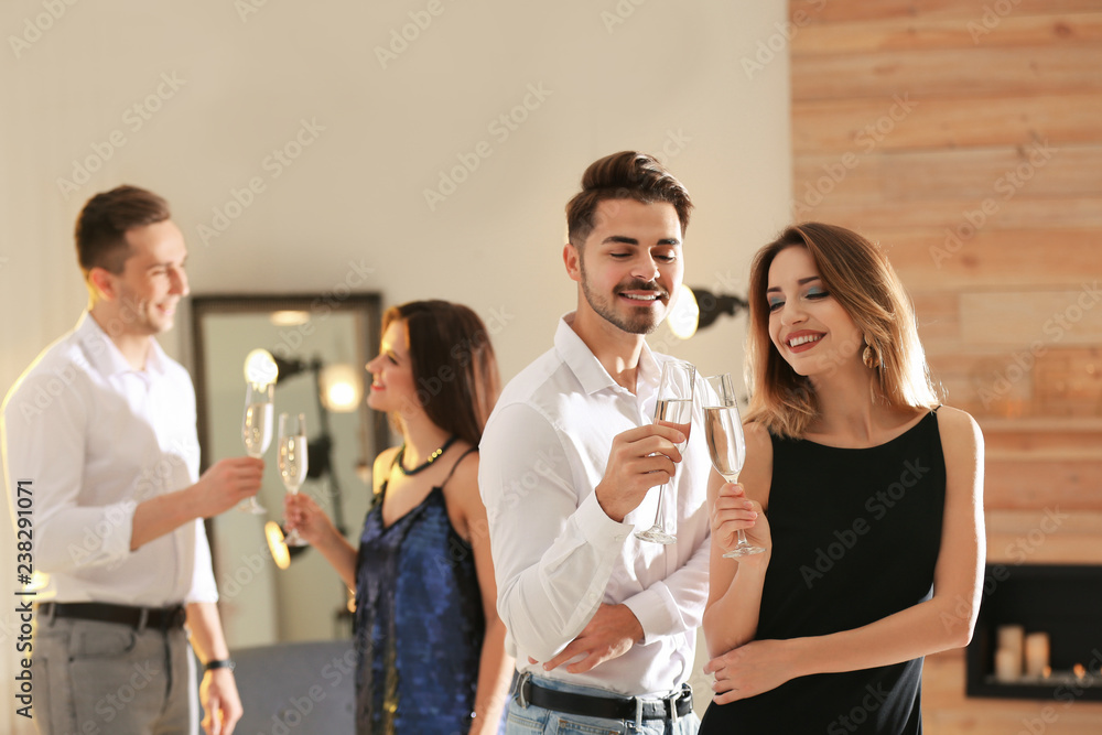 Sticker Friends clinking glasses with champagne at party indoors