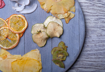 Dried fruits in wooden tray on gray wooden background