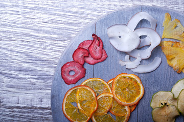 Dried fruits in wooden tray on gray wooden background