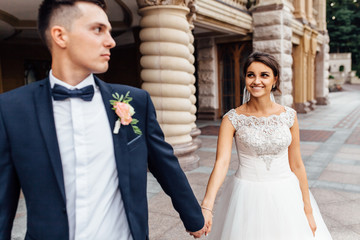 Naklejka premium portrait of the bride and groom near the building, a couple in love