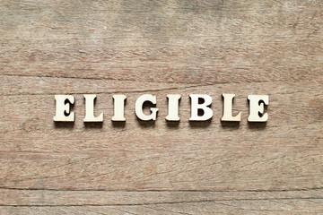Letter block in word eligible on wood background