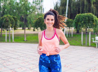 Young beautiful fit woman is running in the park. Healthy concept