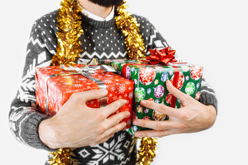 man with a Christmas gift in his handsman holding two Christmas giftsbackground, gift close-up