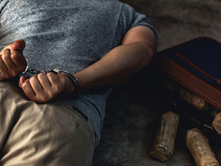 Law and police concept. Arrest drug trafficker with handcuffs.