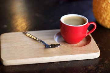  Red cup of coffee on wooden tray