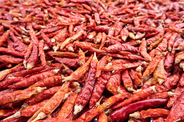 Pile of dried red chili peppers background, food ingredient.