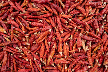 Fototapeta premium Pile of dried red chili peppers background, food ingredient, top view .