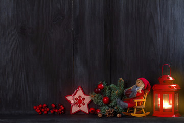 Christmas and New Year background with candle, light, decorations and gift box on wooden shelf. copy space