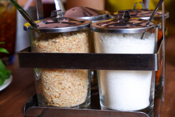 Thai condiment In a glass container. Cayenne pepper, sugar, fish sauce, vinegar, peanut mashed, For Thai food.