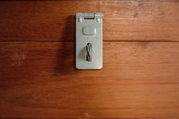 Close up of Metal Hasp staple on wooden box, Key Locking Devices to secure storage.