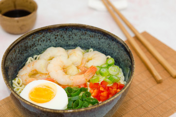 Ramen noodles soup with shrimps, egg and vegetables. Miso ramen soup.  Asian noodle soup with shrimps, egg and vegetables