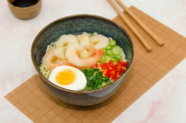 Ramen noodles soup with shrimps, egg and vegetables. Miso ramen soup.  Asian noodle soup with shrimps, egg and vegetables
