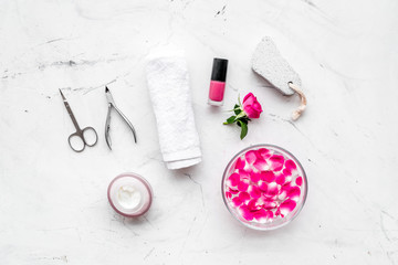 manicure and pedicure equipment for nail bar set on white stone background top view mockup