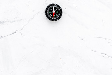 direction and movement concept with compass on stone background top view mock up