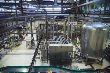 Modern brewery production line. Large vat for beer  fermentation and maturation, pipelines and...