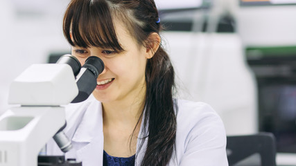 medical technologist is working in the laboratory. Using a microscope for detect the objects that are too small for the naked eye. Picture for concept such as hospital, doctor, health and science.