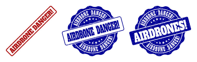 Fototapeta premium AIRDRONE DANGER! grunge stamp seals in red and blue colors. Vector AIRDRONE DANGER! marks with grunge texture. Graphic elements are rounded rectangles, rosettes, circles and text captions.