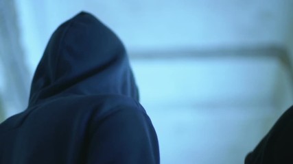 High school students sneaking along corridor, look around, run away from classes