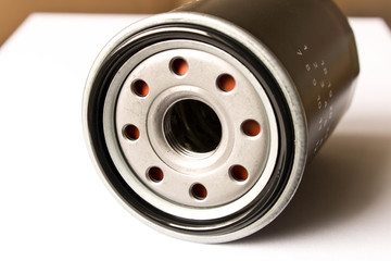 New car oil filter isolated on white background . Close up