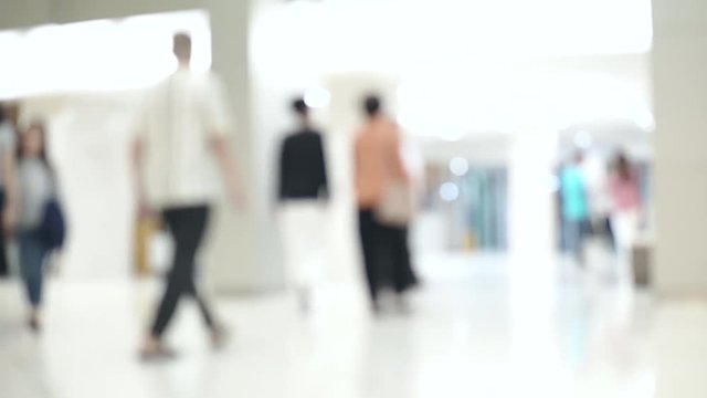 Blurred unidentified patient and medical staff walking in the hospital for background use. Still shot 4K video.