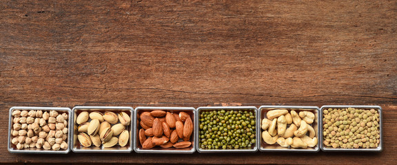 collection of different legumes on wooden background