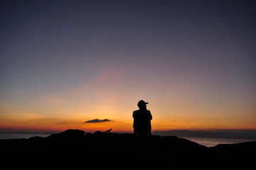 man relex at sea sunset