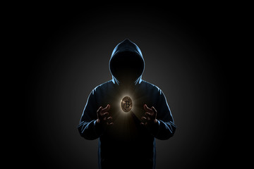 Golden Bitcoin floating above of hacker's hand in dark background. Finance, business, e-commerce or cyber crime concept © poravute