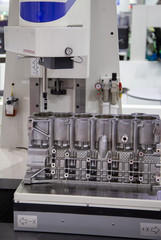 Roundness and cylindrical profile measuring instrument inspecting on engine cylinder bore. Industrial manufacturing.