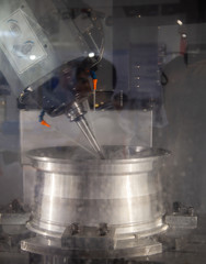 Car alloy wheel machining on high precision CNC machining center machine. Industrial metalworking...