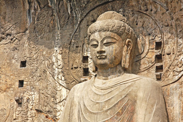 Fototapeta premium Longmen Grottoe : The Buddha sculpture of Fengxian Cave (or Li Zhi Cave) The world heritage site, Chinese Buddhist art. Located in Louyang, Henan province China. Selective focus.
