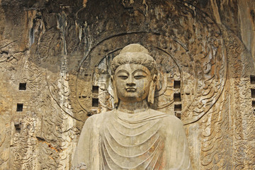 Fototapeta na wymiar Longmen Grottoe : The Buddha sculpture of Fengxian Cave (or Li Zhi Cave) The world heritage site, Chinese Buddhist art. Located in Louyang, Henan province China. Selective focus.