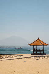 gazebo on the ocean on the background of a volcano