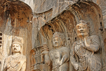 Longmen Grottoes : Massive Buddhist sculptures at main grotto Fengxiansi cave. The world heritage site, Chinese Buddhist art. Located in Louyang, Henan province China. Selective focus.