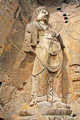 Fototapeta na wymiar Longmen Grottoes : The Bodhisattava sculptures of Fengxian Cave (or Li Zhi Cave) The world heritage site, Chinese Buddhist art. Located in Louyang, Henan province China. Selective focus.