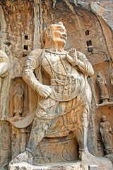 Longmen Grottoes : Massive Buddhist sculptures in the main grotto.The world heritage site, Chinese Buddhist art. Located in Louyang, Henan province China. Selective focus.