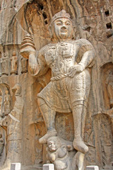 Longmen Grottoes : Massive Buddhist sculptures in the main grotto.The world heritage site, Chinese Buddhist art. Located in Louyang, Henan province China. Selective focus.