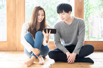 young asian couple relaxing in living room
