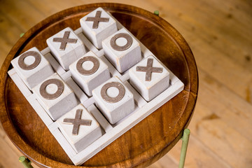 Wooden tic tac toe OX game.The concept of strategy, risk, competition in business. vintage letterpress printing block X and O in wooden grunge typesetter box.cross-zero.Gambling for money