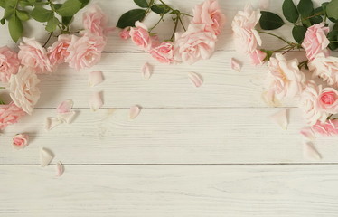 Flowers background banner. Bouquet of beautiful pink roses on white wooden background.Top view.Copy space