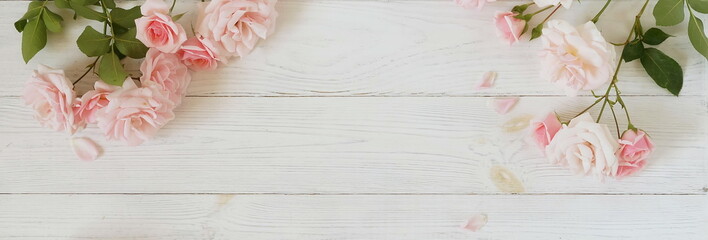 Flowers background banner. Bouquet of beautiful pink roses on white wooden background.Top view.Copy space