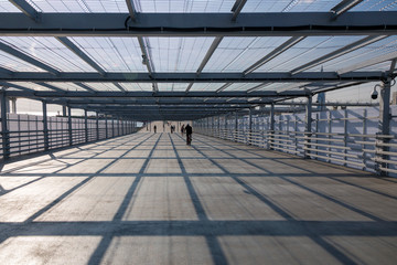 Covered pedestrian crossing over the road near the Gazprom Arena stadium in St. Petersburg