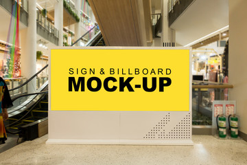 Mock-up blank yellow screen large billboard near escalator in mall
