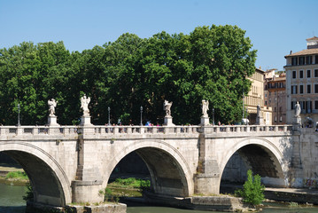 Fototapeta na wymiar Ponte Sant' Angelo bridge. Baroque angel sculpture by Paolo Naldini. Italy - Rome.