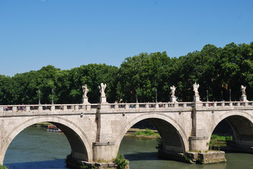 Fototapeta na wymiar Ponte Sant' Angelo bridge. Baroque angel sculpture by Paolo Naldini. Italy - Rome.